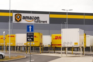 DHL shipping containers in front of Amazon logistics building on March 12, 2017 in Dobroviz, Czech republic.  clipart