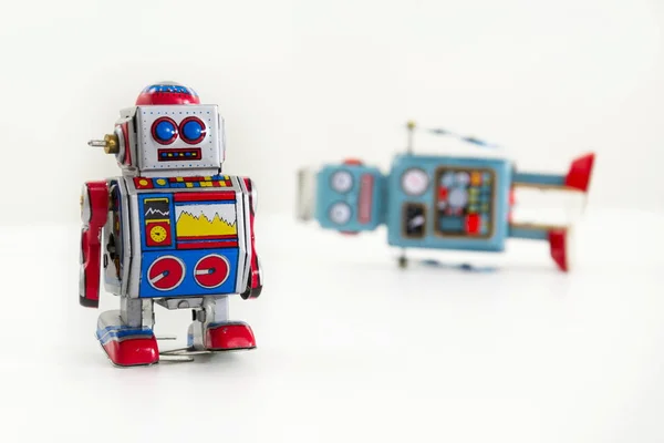 Two vintage tin toy robots isolated on white background
