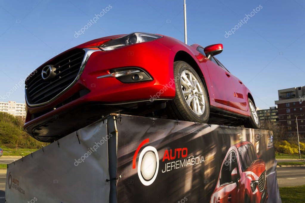 PRAGUE, CZECH REPUBLIC - MARCH 31: Mazda 3 car in front of dealership building on March 31, 2017 in Prague, Czech republic. Mazda set to launch new electric vehicle range by 2019.