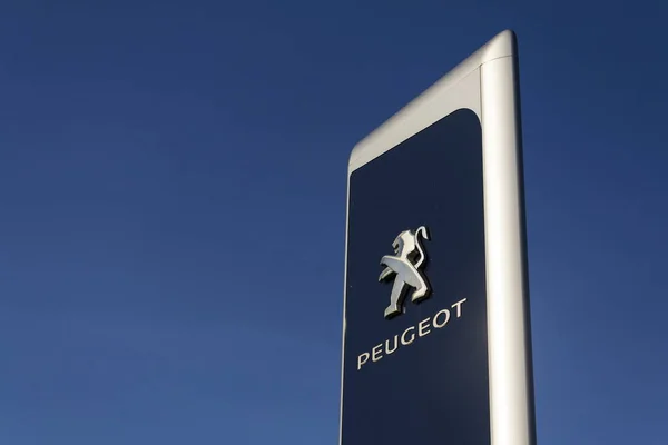 Logotipo de la compañía de automóviles Peugeot frente al edificio de concesionarios el 31 de marzo de 2017 en Praga, República Checa. PSA acordó comprar Opel y su división Vauxhall UK . — Foto de Stock