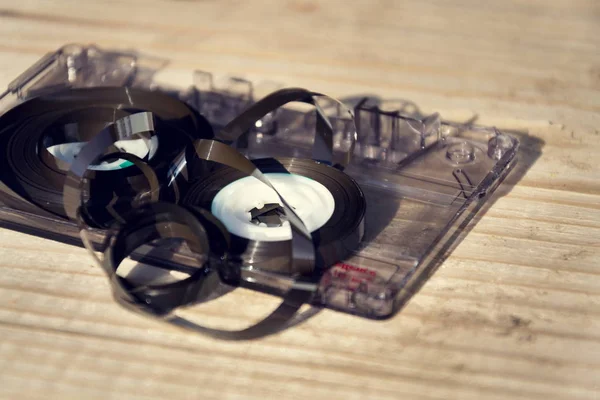 Old broken unwound compact cassette audio tape messed up — Stock Photo, Image