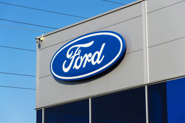 Ford motor company logo on dealership building 