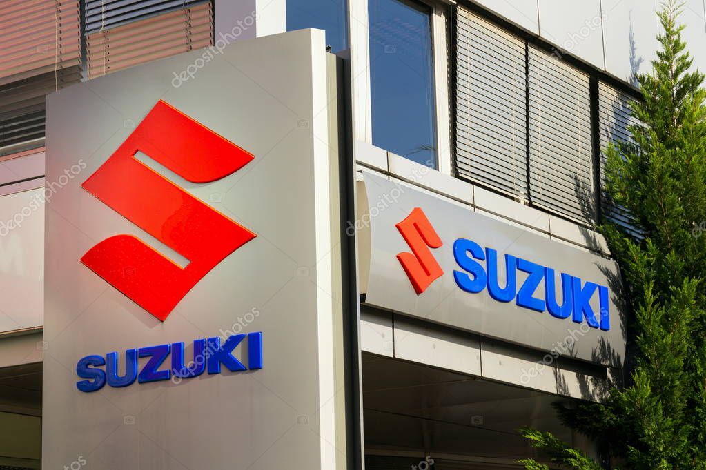 PRAGUE, CZECH REPUBLIC - OCTOBER 27: Suzuki Motor corporation logo on dealership building on October 27, 2017 in Prague. Japanese carmaker is betting on hybrids for its most important market - India.