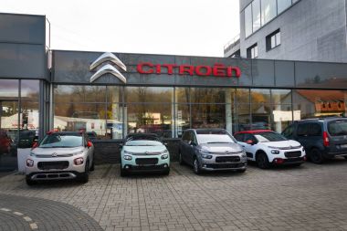 Citroen cars in front of dealership building clipart