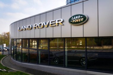 Land Rover car company logo on dealership building clipart