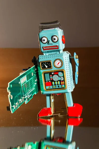 Angry Vintage Tin Toy Robot Carries Green Computer Circuit Board — Stock Photo, Image