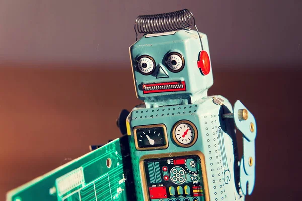 Angry Vintage Tin Toy Robot Carries Green Computer Circuit Board — Stock Photo, Image