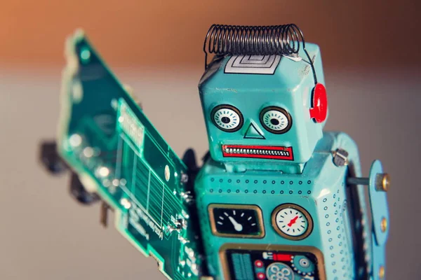 Angry Vintage Tin Toy Robot Carries Green Computer Circuit Board — Stock Photo, Image