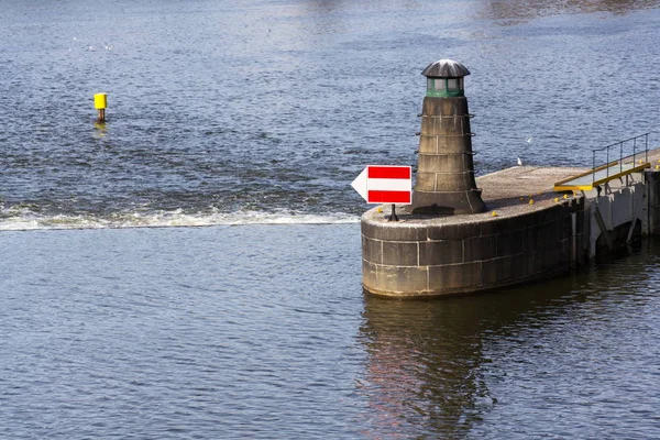 Boat navigation traffic sign arrow on Vltava river weir, Prague, Bohemia, Czech Republic
