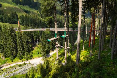 Alpine Golden Gate suspension bridge in Saalbach-Hinterglemm valley, Alps, Austria clipart