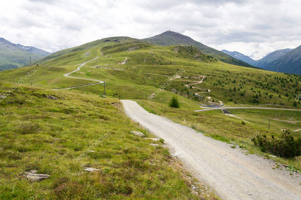 Summer landscape with bikepark Mottolino and mountain Monte della Neve in background, Livigno, Italy, cloudy day