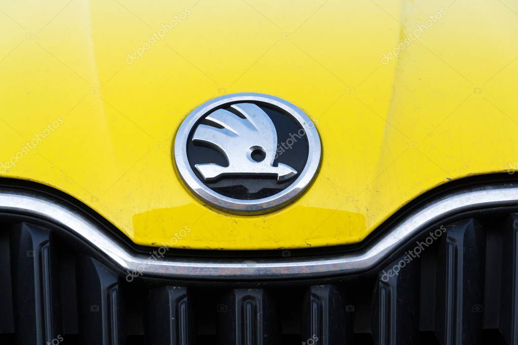 PRAGUE, CZECH REPUBLIC - MARCH 25 2018: Skoda Auto automobile manufacturer from Volkswagen Group company logo on yellow dirty car on March 25, 2018 in Prague, Czech Republic.