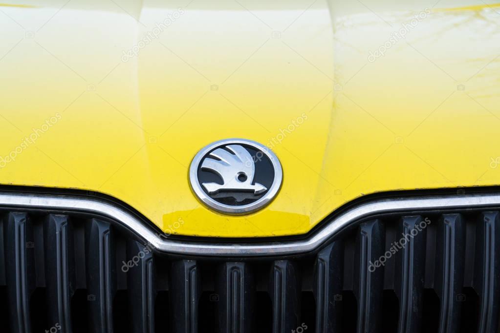PRAGUE, CZECH REPUBLIC - MARCH 25 2018: Skoda Auto automobile manufacturer from Volkswagen Group company logo on yellow dirty car on March 25, 2018 in Prague, Czech Republic.