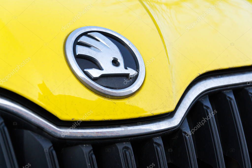 PRAGUE, CZECH REPUBLIC - MARCH 25 2018: Skoda Auto automobile manufacturer from Volkswagen Group company logo on yellow dirty car on March 25, 2018 in Prague, Czech Republic.