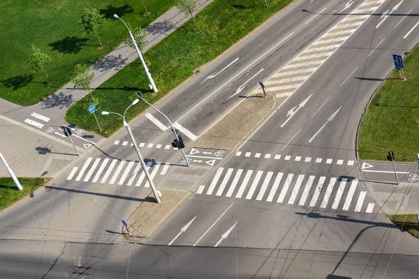 Aerial view of crosswalk and bike crossing line on empty crossroad, driverless technology concept