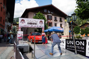 SAALBACH-HINTERGLEMM, AUSTRIA - JUNE 21 2018: People looking at vintage veteran car on June 21, 2018 in Saalbach-Hinterglemm, Austria.