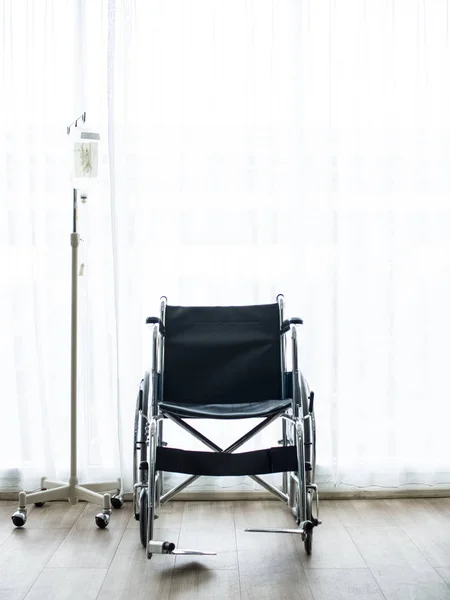 In the hospital, examination nobody and empty room , white isolated for background curtains, no patient armchair wheelchairs seat help care equipment for comfort adult old and saline tubes.