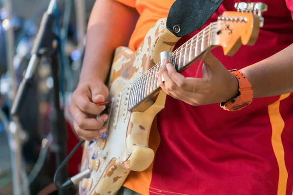 Closeup of a musician playing an electro guitar,