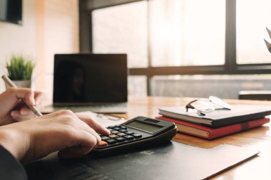 Sayıları hesaplamak için hesap makinesi kullanan bir muhasebeci. Muhasebe, mali rapordan muhasebe ve danışman, hesaplama konseptine çağrı.