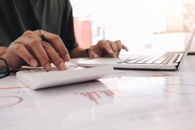 Mali raporu, muhasebe belgesini ve bilgisayarını hesaplamak için hesap makinesi üzerinde çalışan muhasebeci, Business Financial Concep