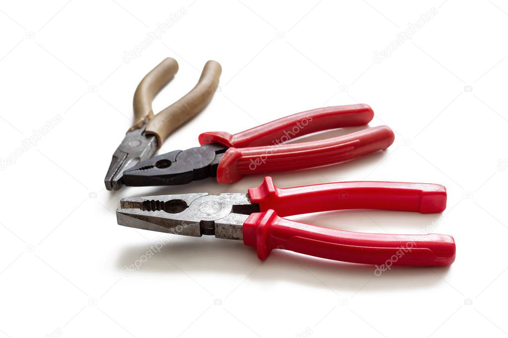 Three pliers with insulating handles, on a white background