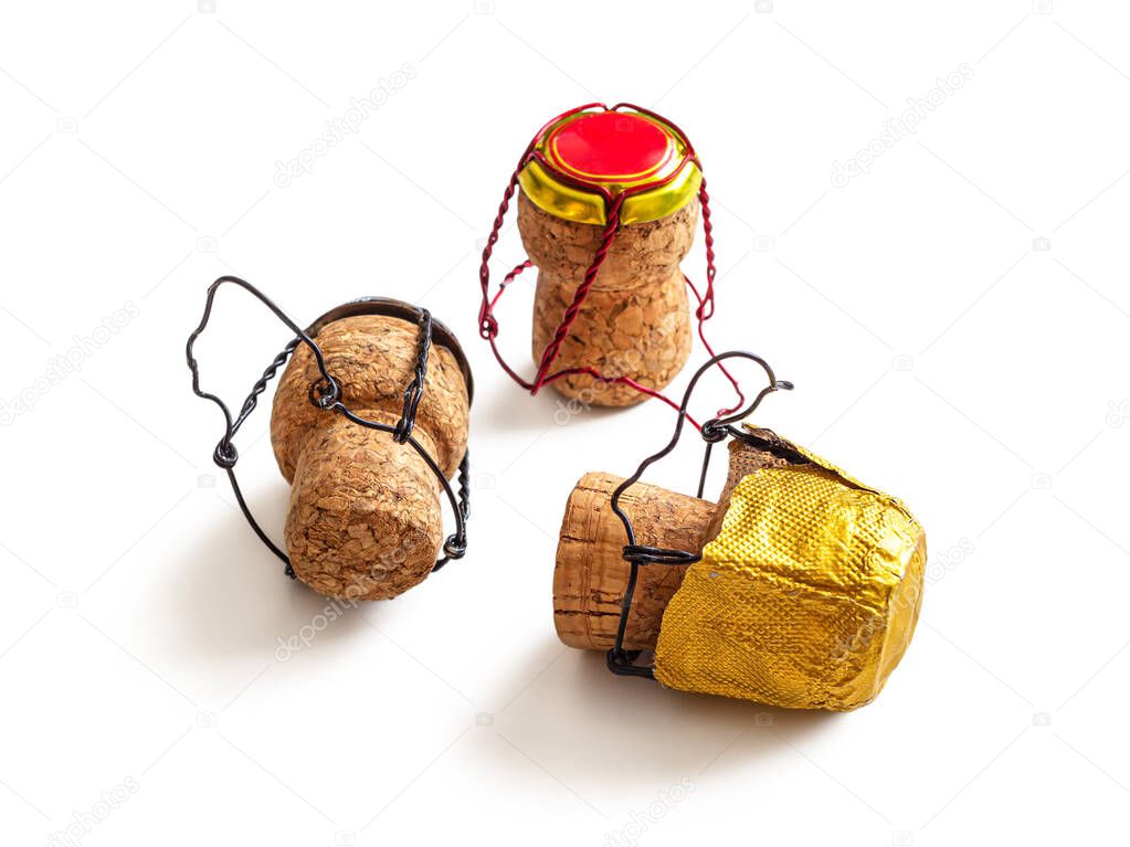 Three used wine champagne corks with a muselet and multi-colored foil