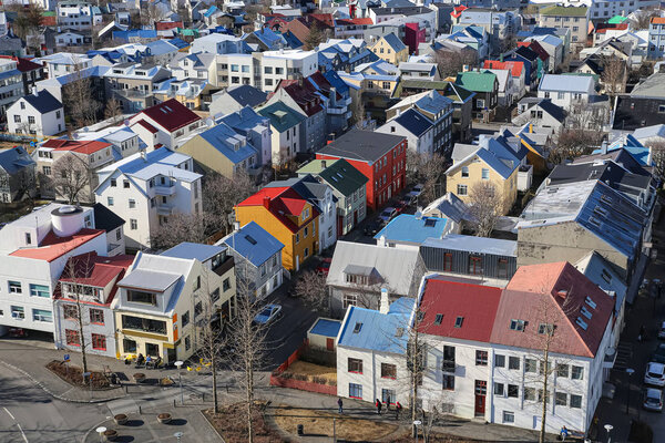 Reykjavik, Iceland, 03.29.2018. Beautiful multi-colored houses, made in a Scandinavian minimalist style, lit by the morning sun