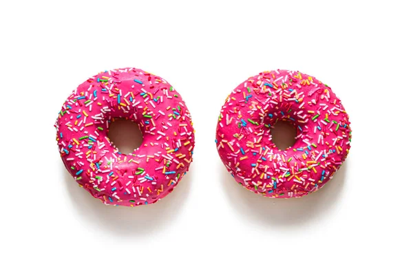 Dois donuts de vidro rosa em um fundo branco — Fotografia de Stock