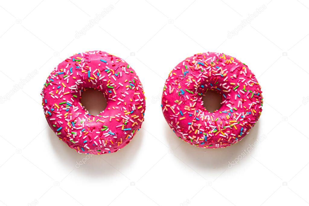 Two pink glazed doughnuts on a white background