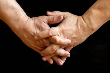 Crossed fingers of hands