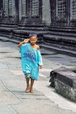 A boy in a blue T-shirt in Angkor Wat