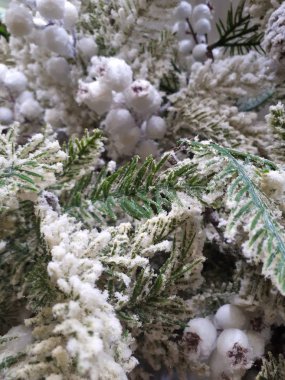  close-up of abstract, bright, Christmas background from garlands, Christmas tree, decorations, snow, berries and fruits, toys, ice