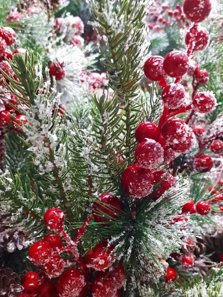  close-up of abstract, bright, Christmas background from garlands, Christmas tree, decorations, snow, berries and fruits, toys, ice