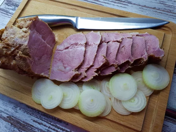 用洋葱在木制盘子上的熏肉特写 — 图库照片