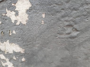  Betondan yapılmış dekoratif bir duvarın, karakteristik kaba, gözenekli bir dokusu, soyut koyu ve aydınlık lekeleri var.