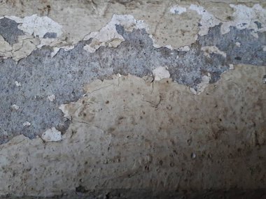 Bokeh efekti ve karakteristik kaba gözenekli dokusu, soyut koyu ve aydınlık lekeleri olan dekoratif bir duvarın yakın çekimi.