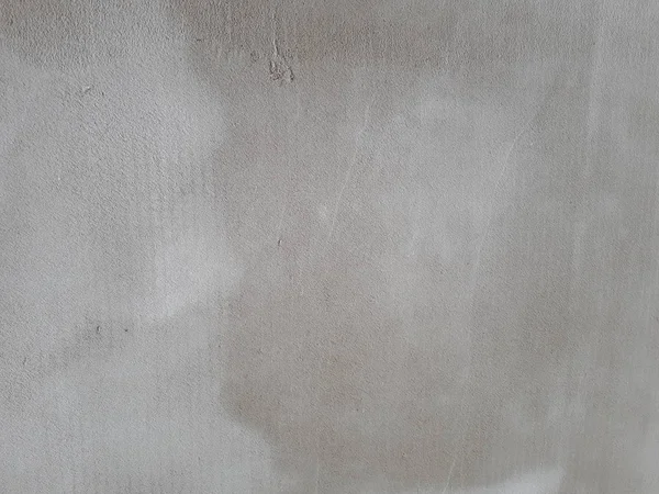  Betondan yapılmış dekoratif bir duvarın, karakteristik kaba, gözenekli bir dokusu, soyut koyu ve aydınlık lekeleri var.