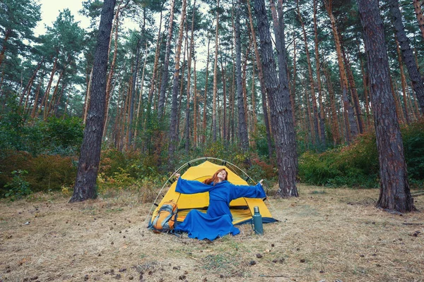 푸른 옷을 입고 손을 뻗치고 숲에서 야영을 하고 있는 소녀 — 스톡 사진