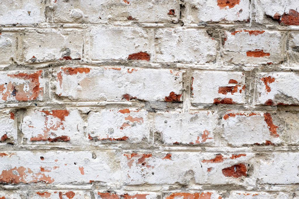 Loft damaged texture, wallpaper and background with painted red bricked wall colored in white