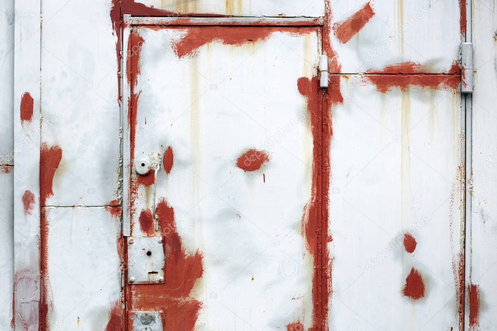 Painted in white and red old damaged iron door and wall texture and background