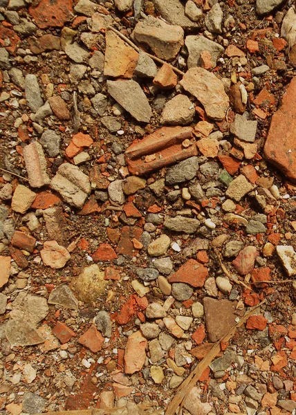 Red granite fine gravel, stone background with red pebbles. Stone texture. Top view of with colorful natural stone.