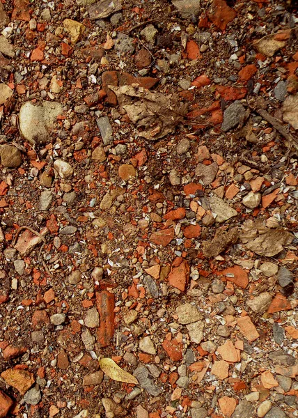 Red granite fine gravel, stone background with red pebbles. Stone texture. Top view of ground decor with colorful natural stone