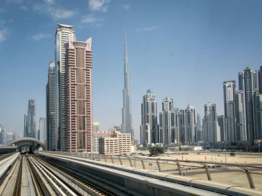 Dubai metro hattı boyunca modern gökdelenler ve Burdj-Halifa