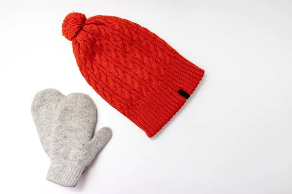 Orange knitted hat and warm winter mittens on white background — Stock Photo, Image