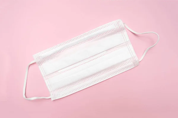 Medical surgical textyle filter protective mask on pink background, illness and flu defense — Stock Photo, Image