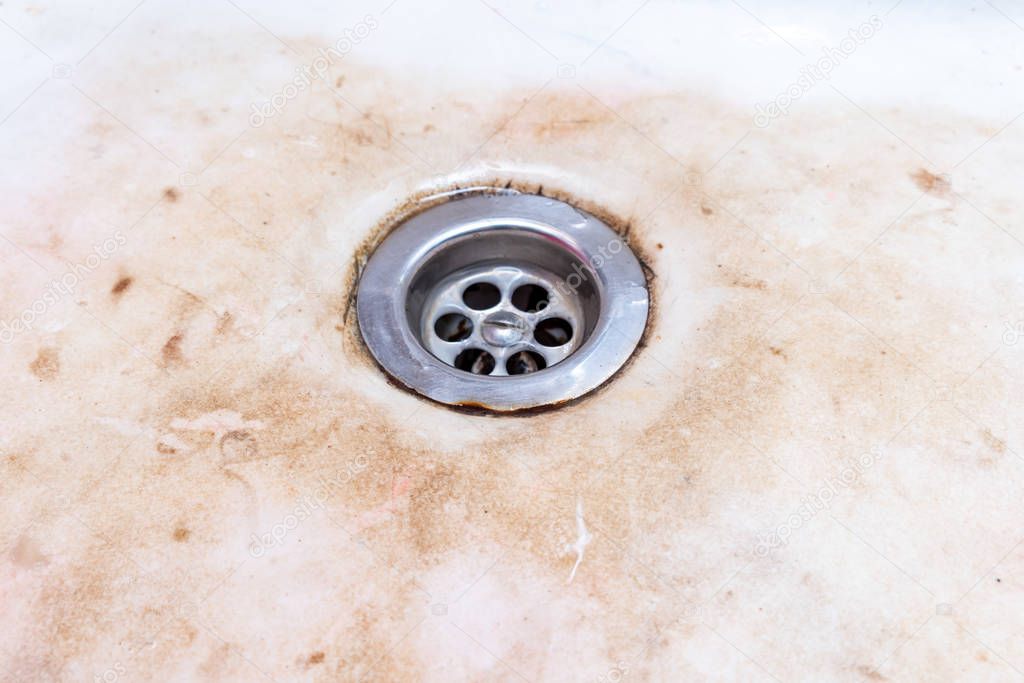 Dirty unhygienic kitchen sink with limescale and rust, dirty house and kitchen cleaning concept