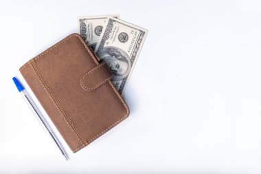 Dollars, notebook and a pen on white background close up as a symbol of wealth and financial prosperity, earning money and richness, copy space