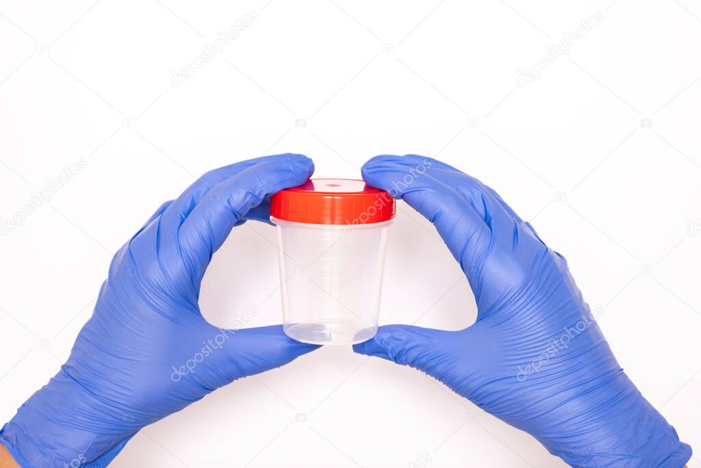 Hands of a doctor or nurse in blue gloves holding an empty analysis container, white background
