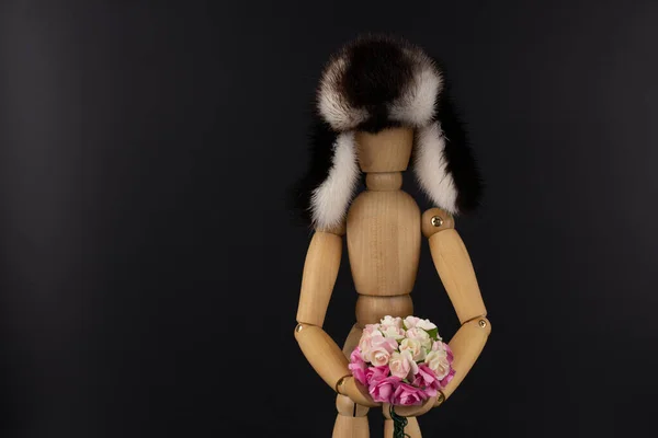 Wooden doll with a bouquet of flowers. — Stock Photo, Image