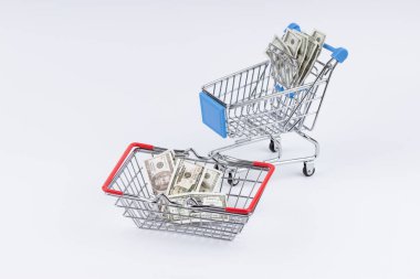 Shopping cart with moneys on white background